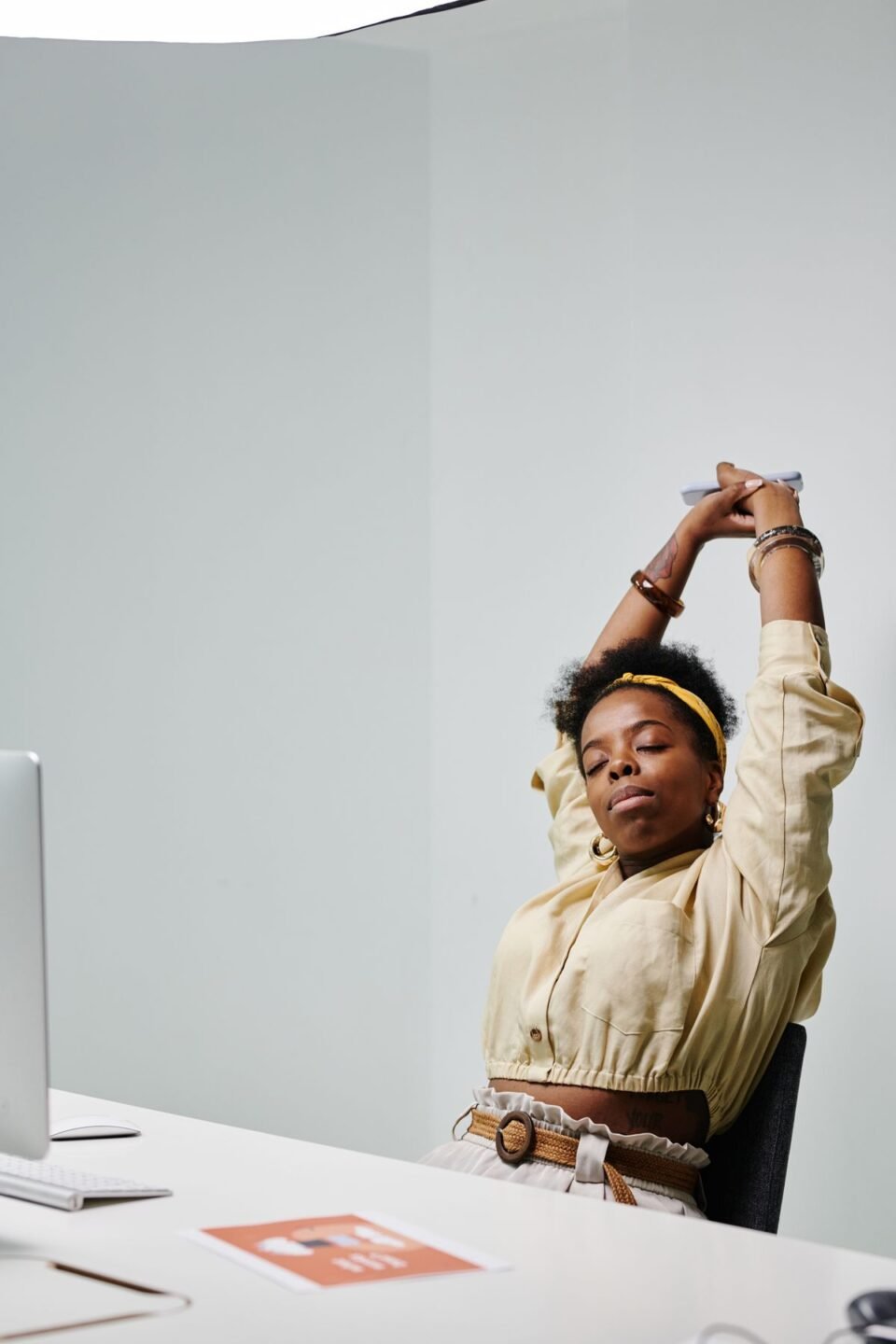 Desk stretching routine for beginners: office worker stretching at a desk