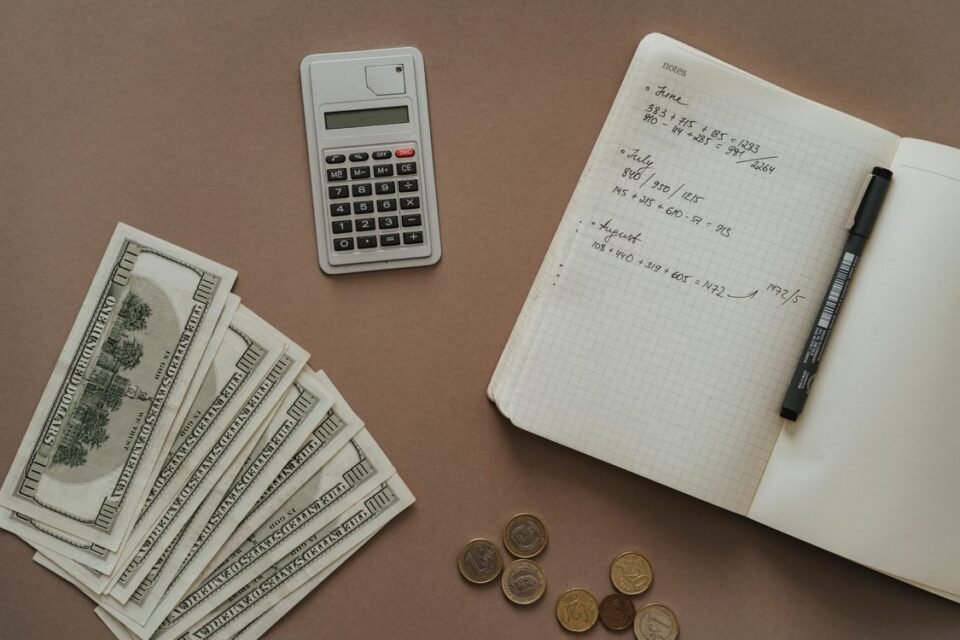Monthly budget for beginners plan written in a notebook with a calculator